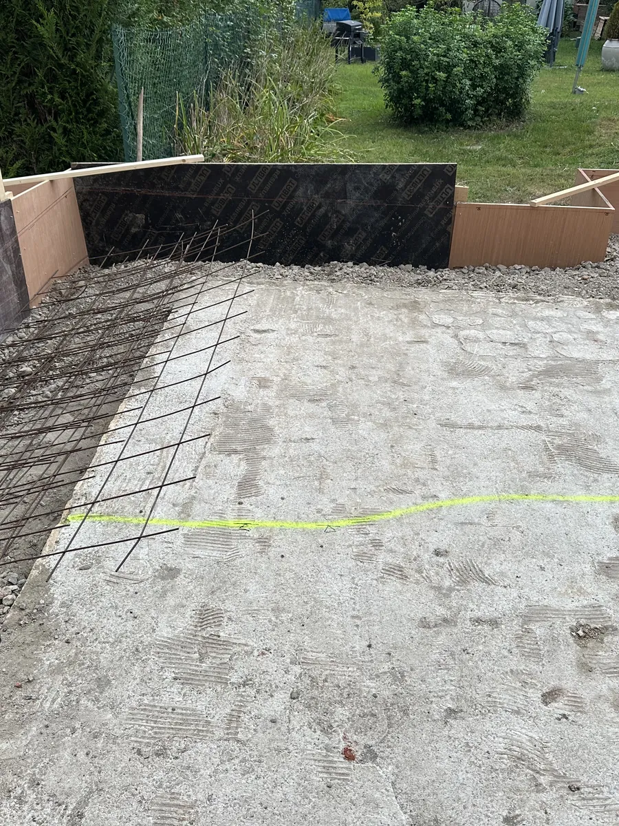 Treillis soudé posé dans un coffrage, au fond d'un jardin